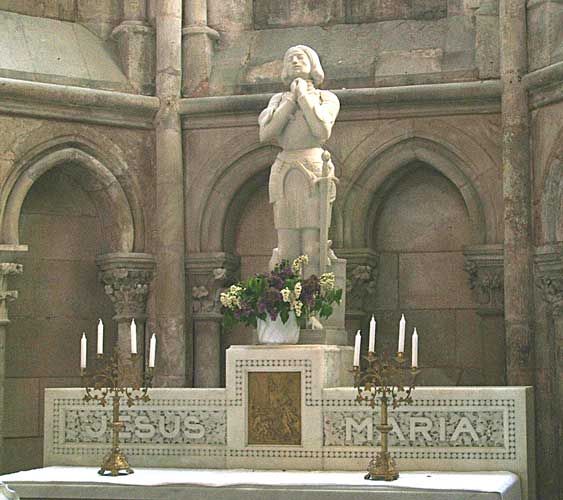 Statue of Joan of Arc in a church with words Jesus Maria