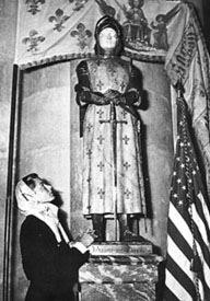Ingrid praying before statue of Saint Joan of Arc at Reims 
Cathedral